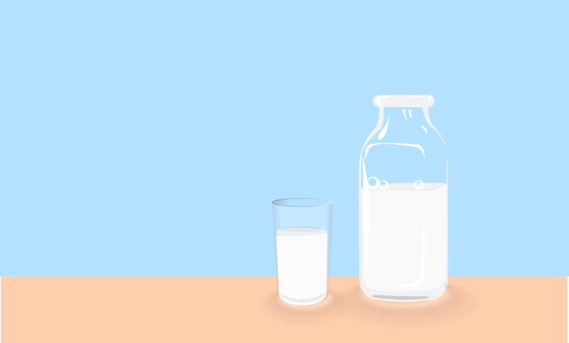 Bottle of milk and glass of milk on table