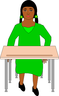 Girl in pigtails sitting at student desk