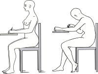 2 women sitting writing exams